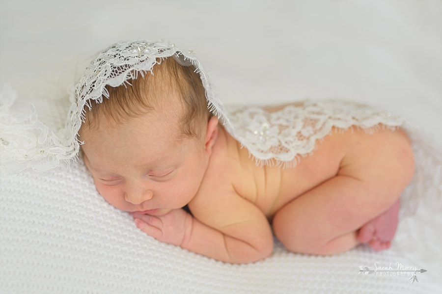 PictureNewborn Photography | Newborn Baby girl posed on white blanket with mom's wedding veil in Memphis, TN