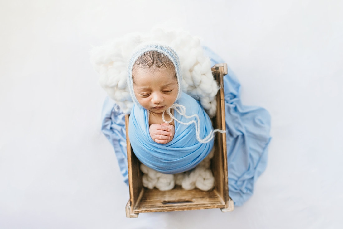 newborn baby boy sleeping in wooden crate for newborn photos in memphis
