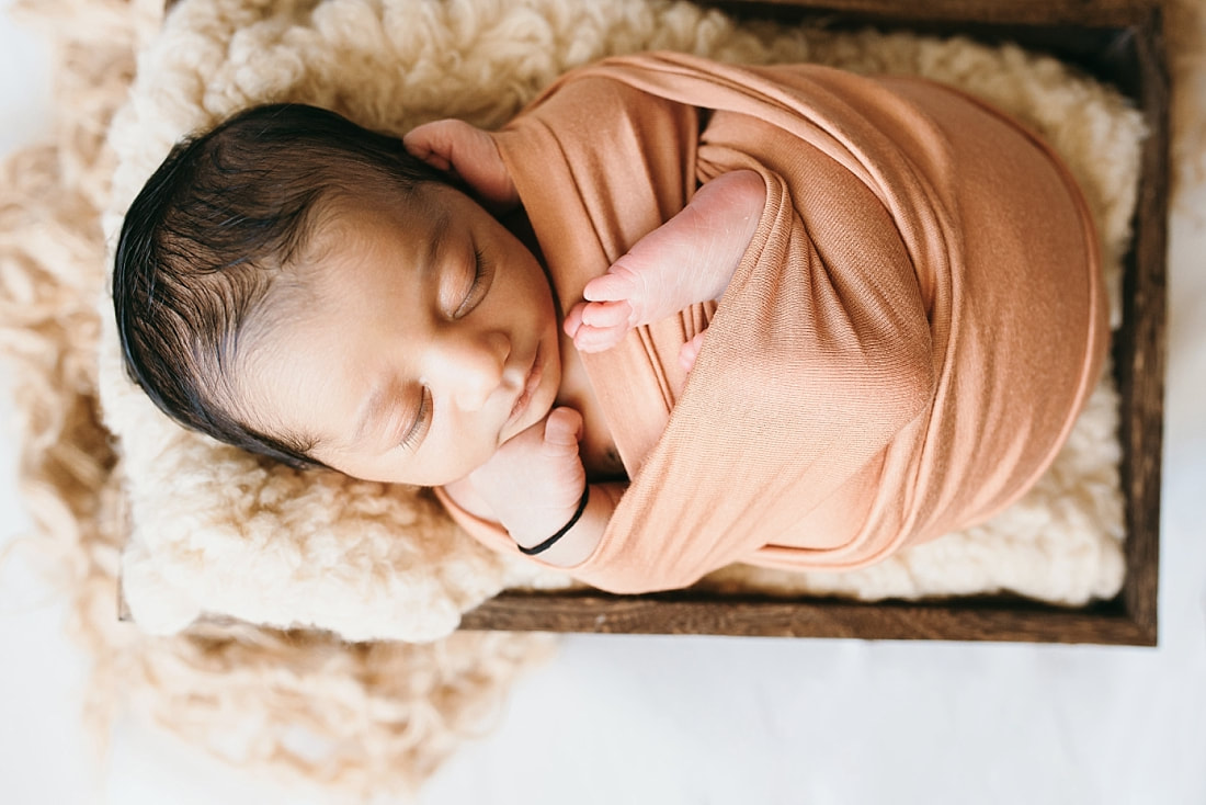 baby boy wrapped in tan wrap for newborn photos memphis