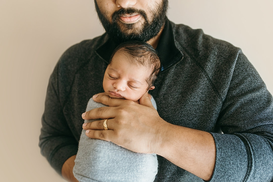 newborn baby in daddy's hands at newborn session in memphis