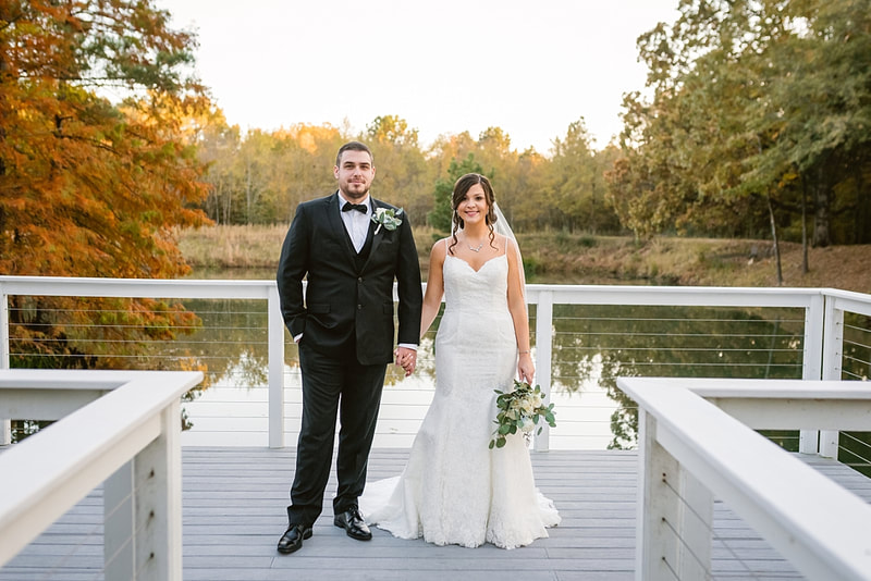 bride and groom holding hands on the dock at Orion Hill in Arlington, TN
