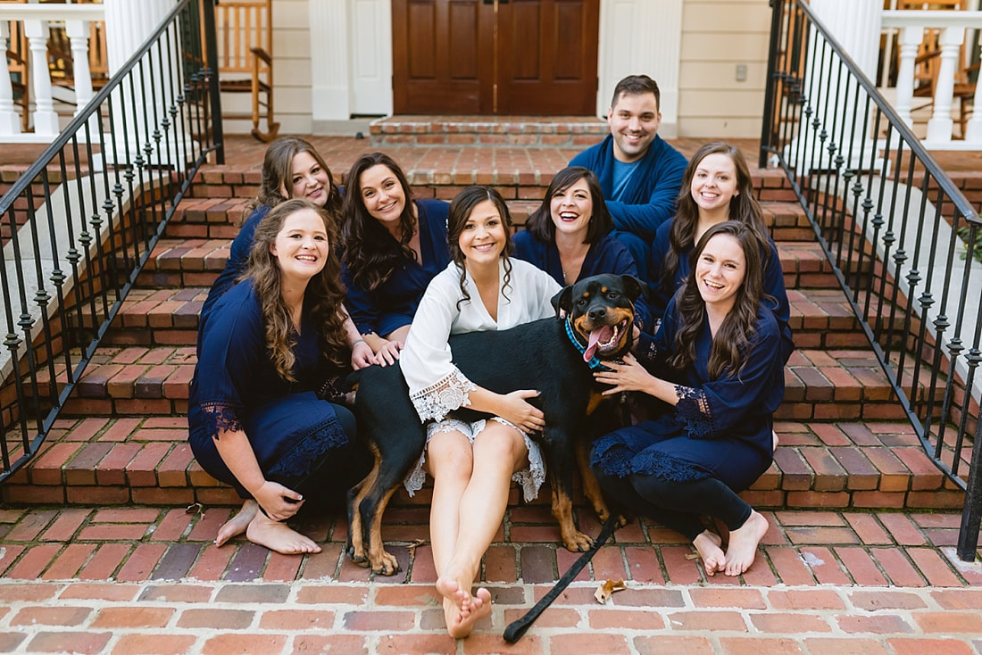 bride with bridesmaids and dog sitting on front steps at Orion Hill in Arlington, TN