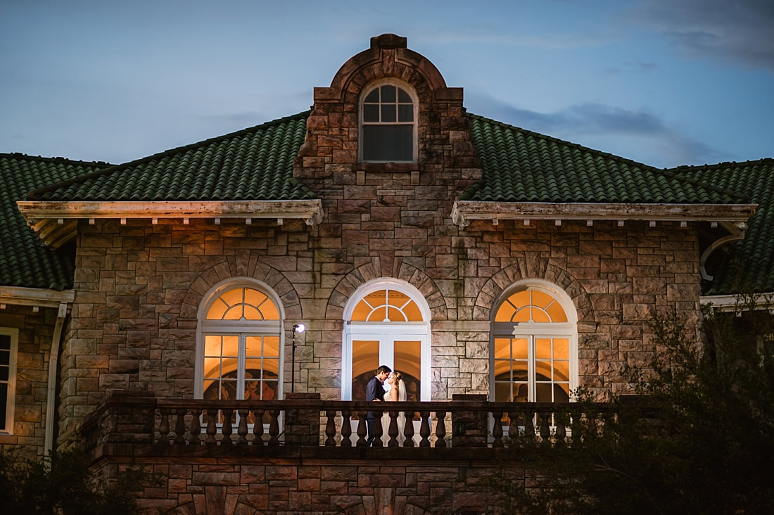 night portrait of bride and groom on the balcony of the Pink Palace + Pink Palace Wedding + Memphis, TN