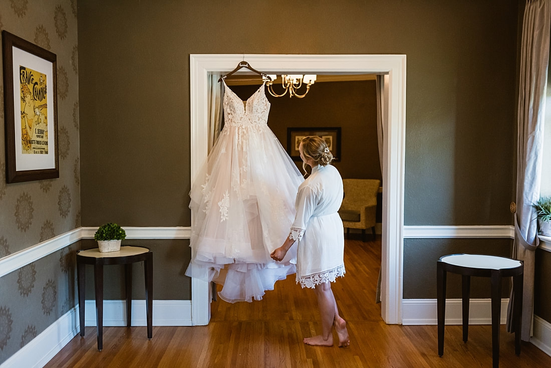 Bride admiring her wedding dress + Pink Palace Wedding + Memphis, TN