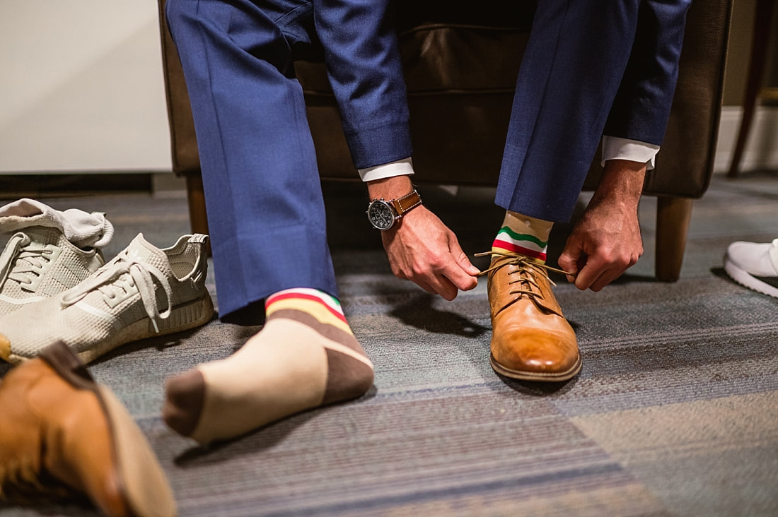 groom tying his shoes + Pink Palace Wedding + Memphis, TN