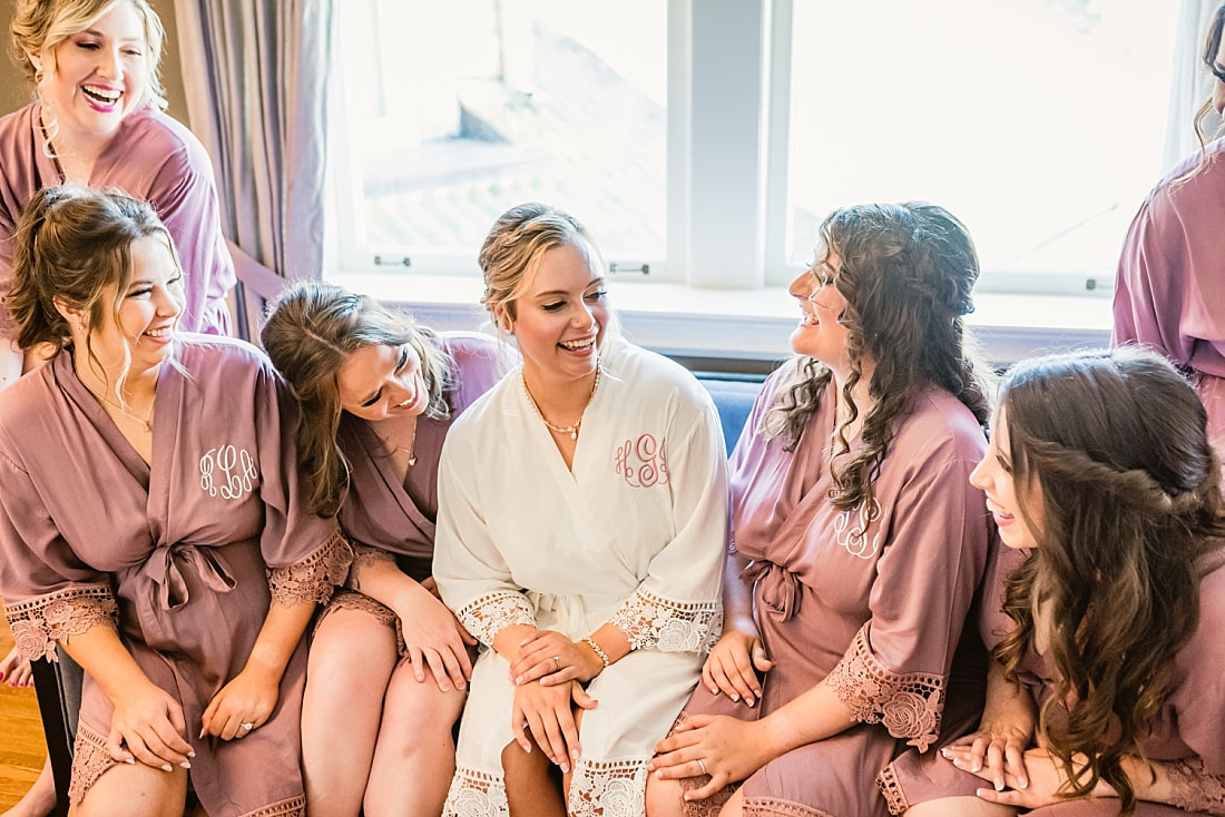 bride with her bridesmaids in their matching robes + Pink Palace Wedding + Memphis, TN