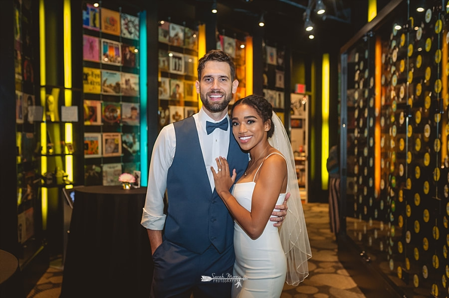 Bride and groom posing in the hallway of records at the Stax Museum