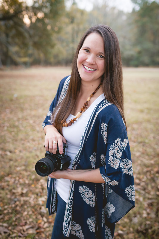 Sarah Morris of Sarah Morris Photography holding her Nikon camera at Shelby Farms Park