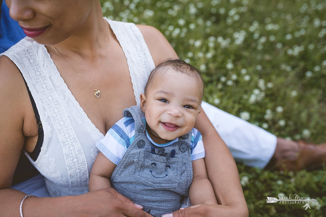 Close up of smiling baby in Family pictures in a field of clover at Shelby Farms Park