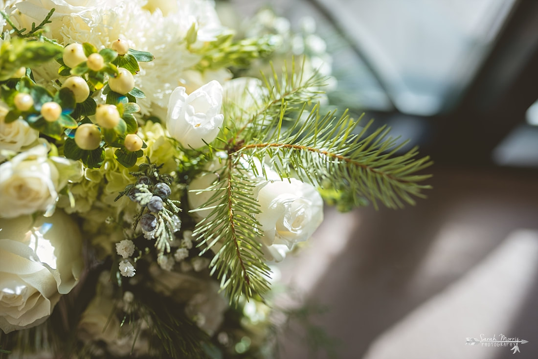 Close up of Winter bridal bouquet by Rachel's Flowers at St. Francis of Assisi Catholic Church