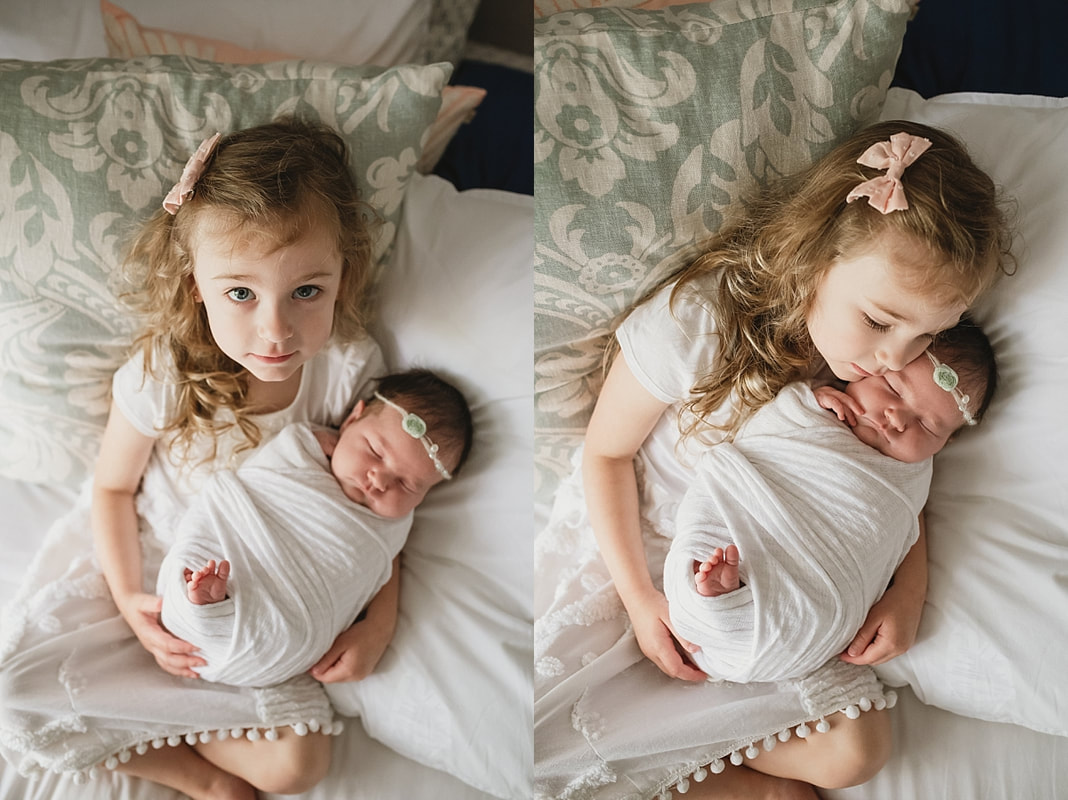 big sister holding newborn baby sister at newborn session in memphis, tn