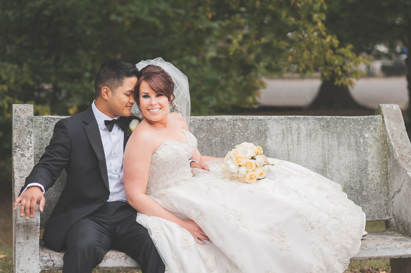 Bride and groom cuddling on a bench at Overton Park