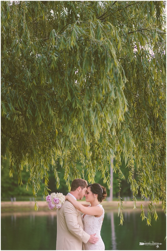 Formal bridal portraits of the bride and groom under a weeping willow tree at Bellevue Baptist Church