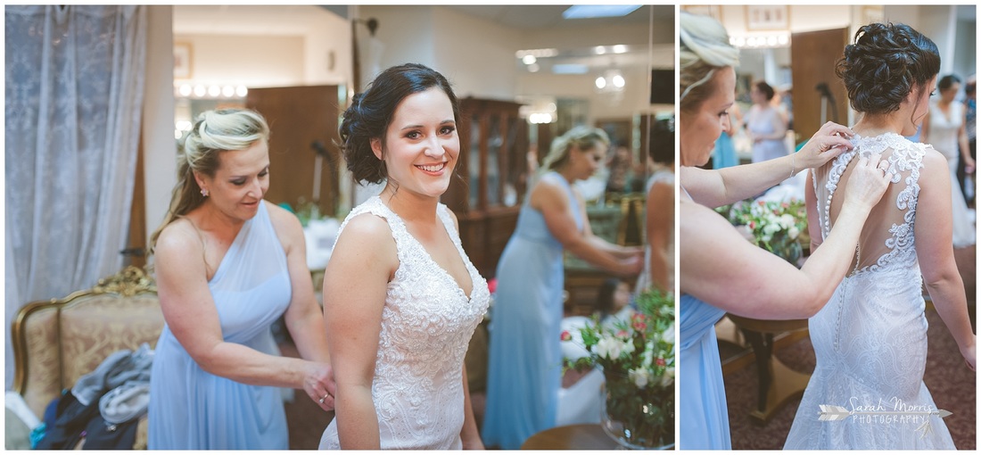 Mother of the bride buttoning bride's dress in the bride's room at Bellevue Baptist Church