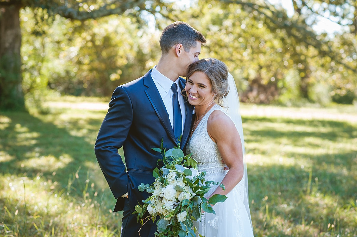 Bride and groom sharing a sweet intimate moment in the woods + Memphis, TN wedding