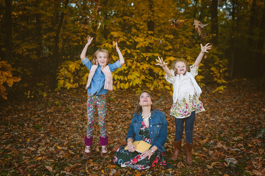 children playing in the fall leaves in collierville, tn