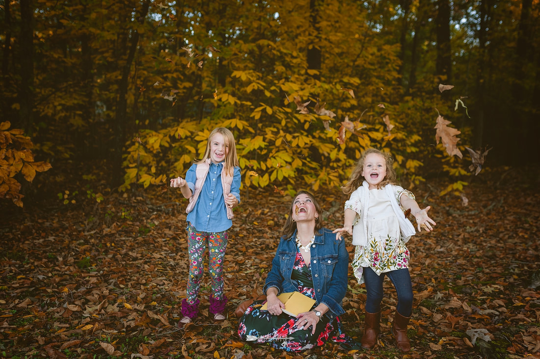 kids throwing fall leaves into the air in collierville 