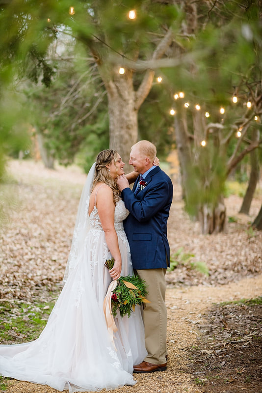 Groom pulling Bride in for a kiss during wedding portraits with Sarah Morris Photography at Green Frog Farm