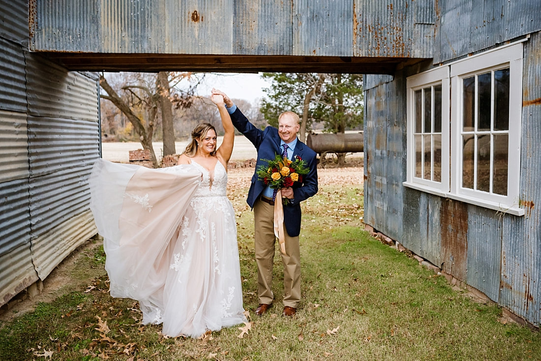 Bride and Groom dancing during wedding photos at the cotton gin at Green Frog Farm with Sarah Morris Photography