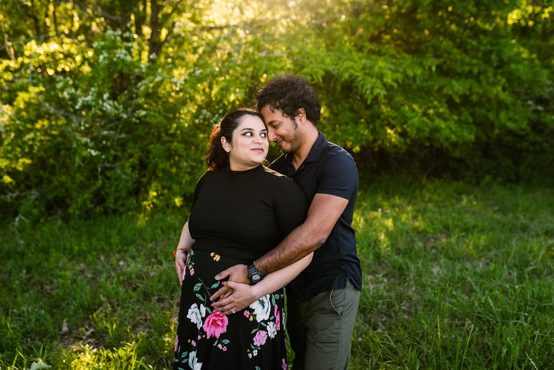 mother and father posing for maternity photos at Shelby Farms in Memphis, TN
