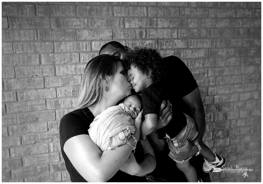 newborn photos of baby girl with mother and father and toddler sibling