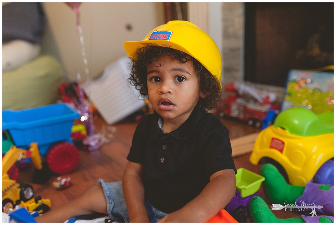 lifestyle portrait of toddler boy playing with toys