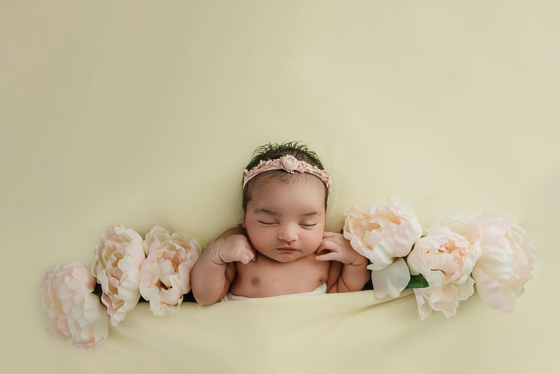 newborn baby girl posed with flowers for newborn session in Memphis, TN