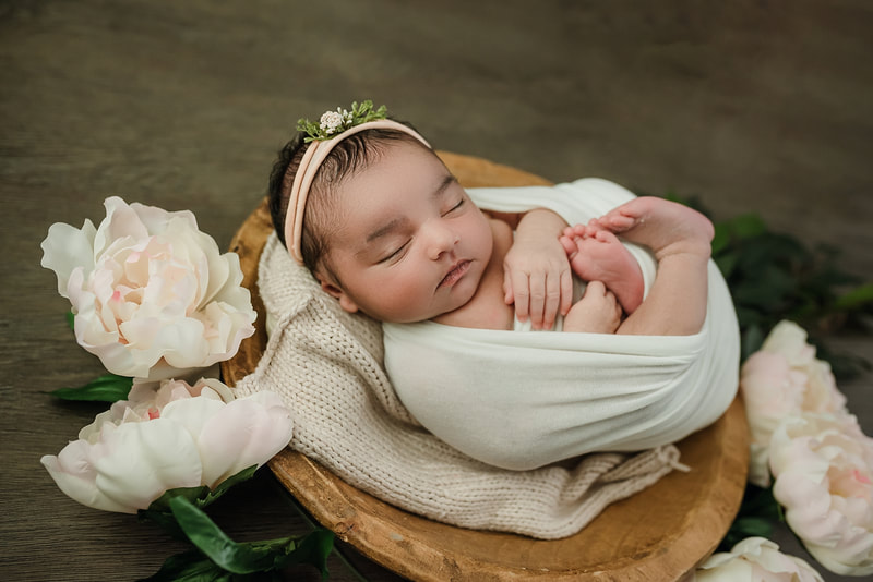 newborn baby girl posed with flowers for newborn session in Memphis, TN