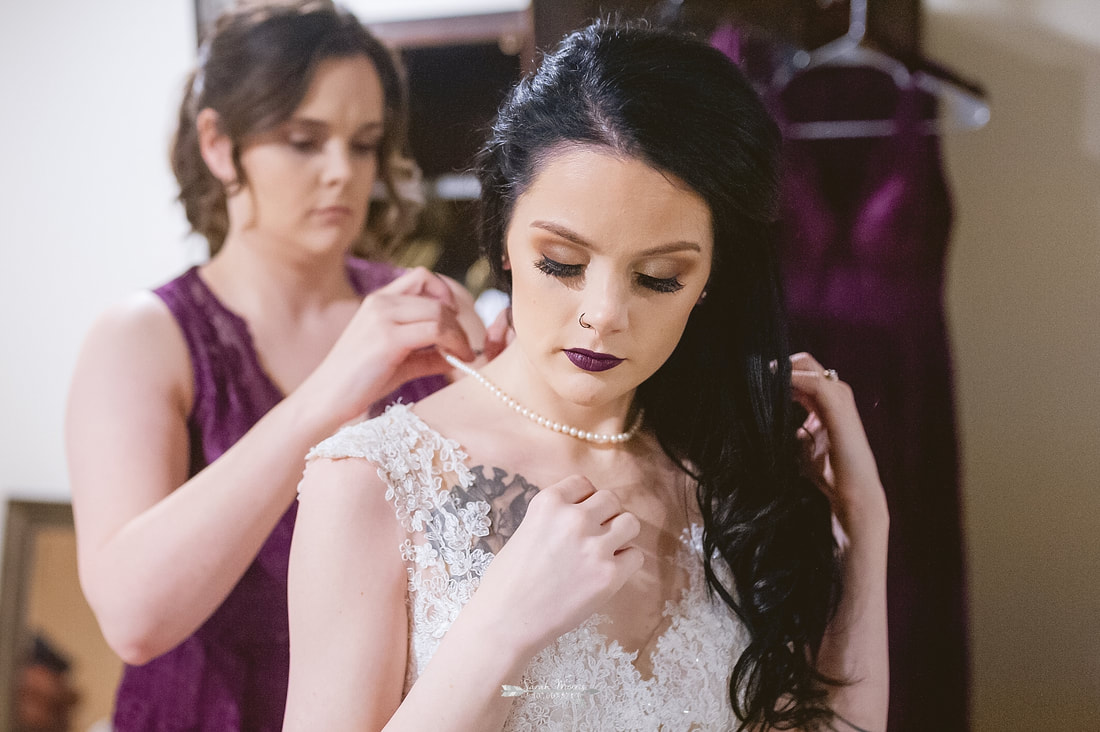 bride's sister fastening bride's pearls at Overton Chapel, Memphis Wedding Photographer