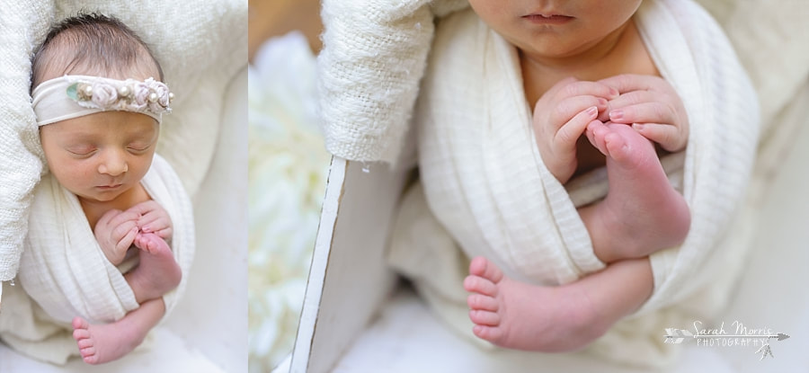 Newborn Photography | Newborn photo of baby girl posed in a white wooden box with white flowers at her Newborn Photo Session in Memphis, TN