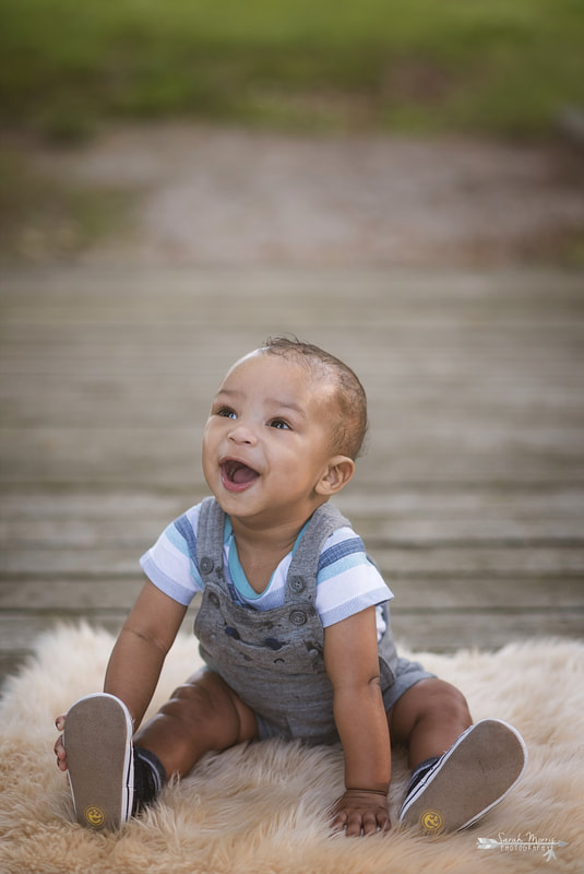 Baby sitting on walking bridge at Shelby Farms Park