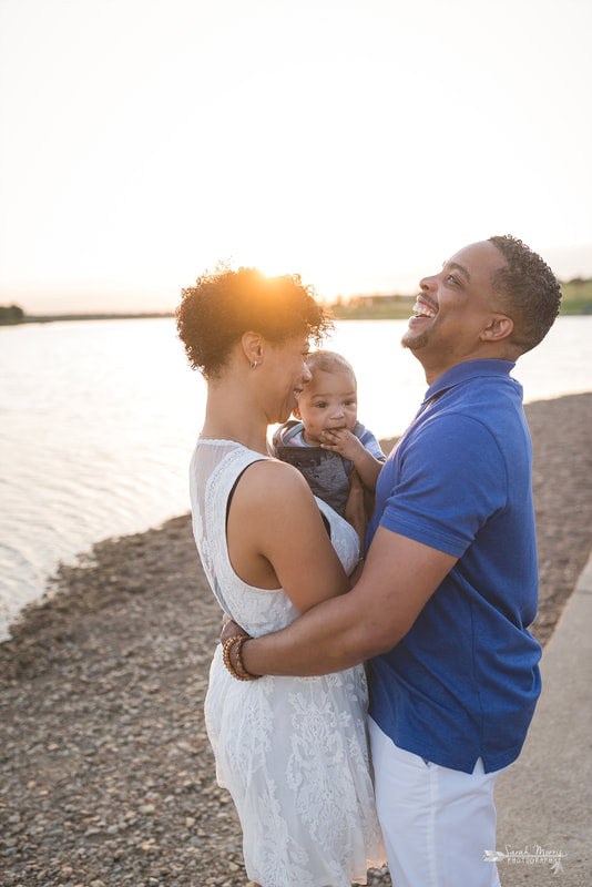 Family pictures on the bank of Patriot Lake at sunset at Shelby Farms Park