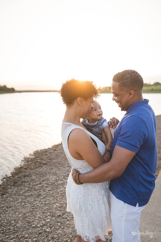 Family pictures on the bank of Patriot Lake at sunset at Shelby Farms Park