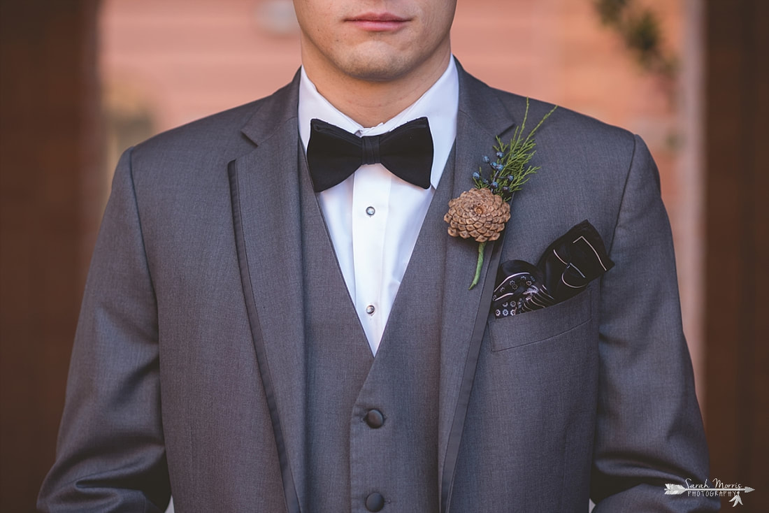 close up of groom's pinecone boutonniere