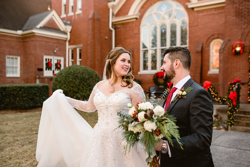 Bride and Groom walking hand in hand at the Collierville Town Square during wedding photos with Sarah Morris Photography